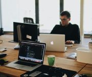 pexels photo 2102416 2102416 A web developer working on code in a modern office setting with multiple devices.